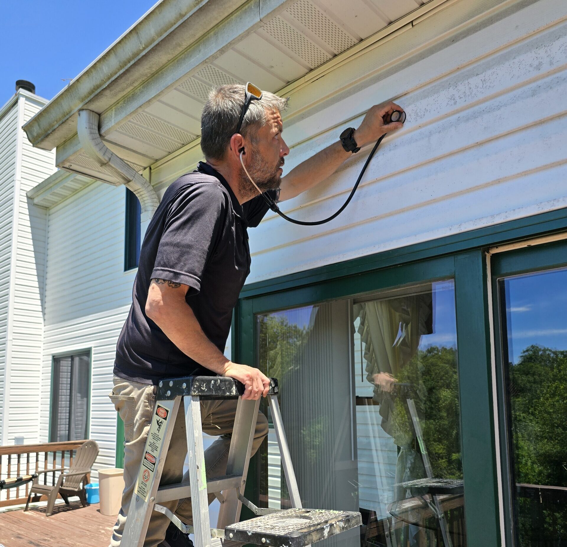 Charlie Roberts, owner of Roberts Pest Control, inspecting a home in St. Louis
