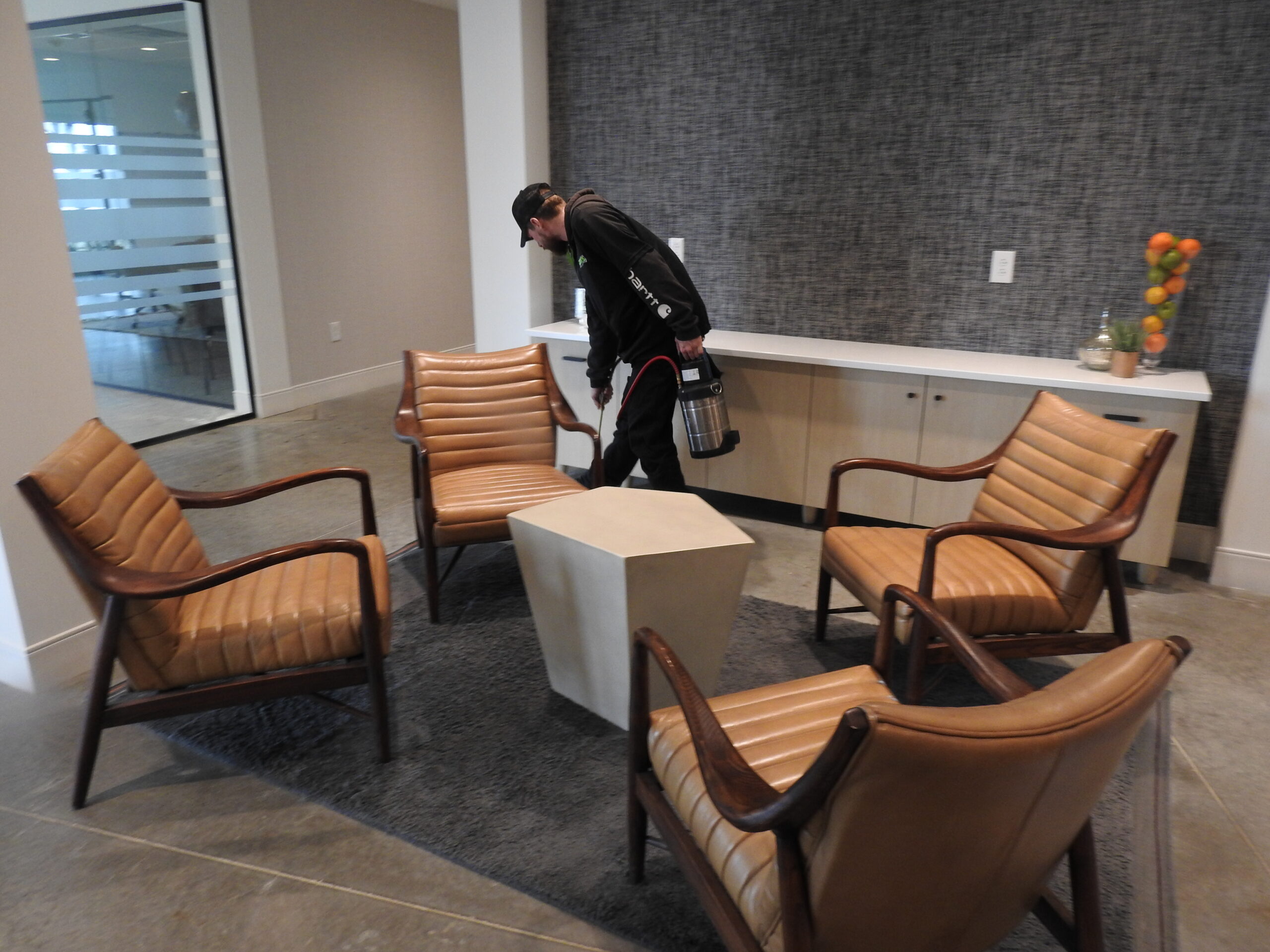 Technician applying treatment inside commercial cabinetry