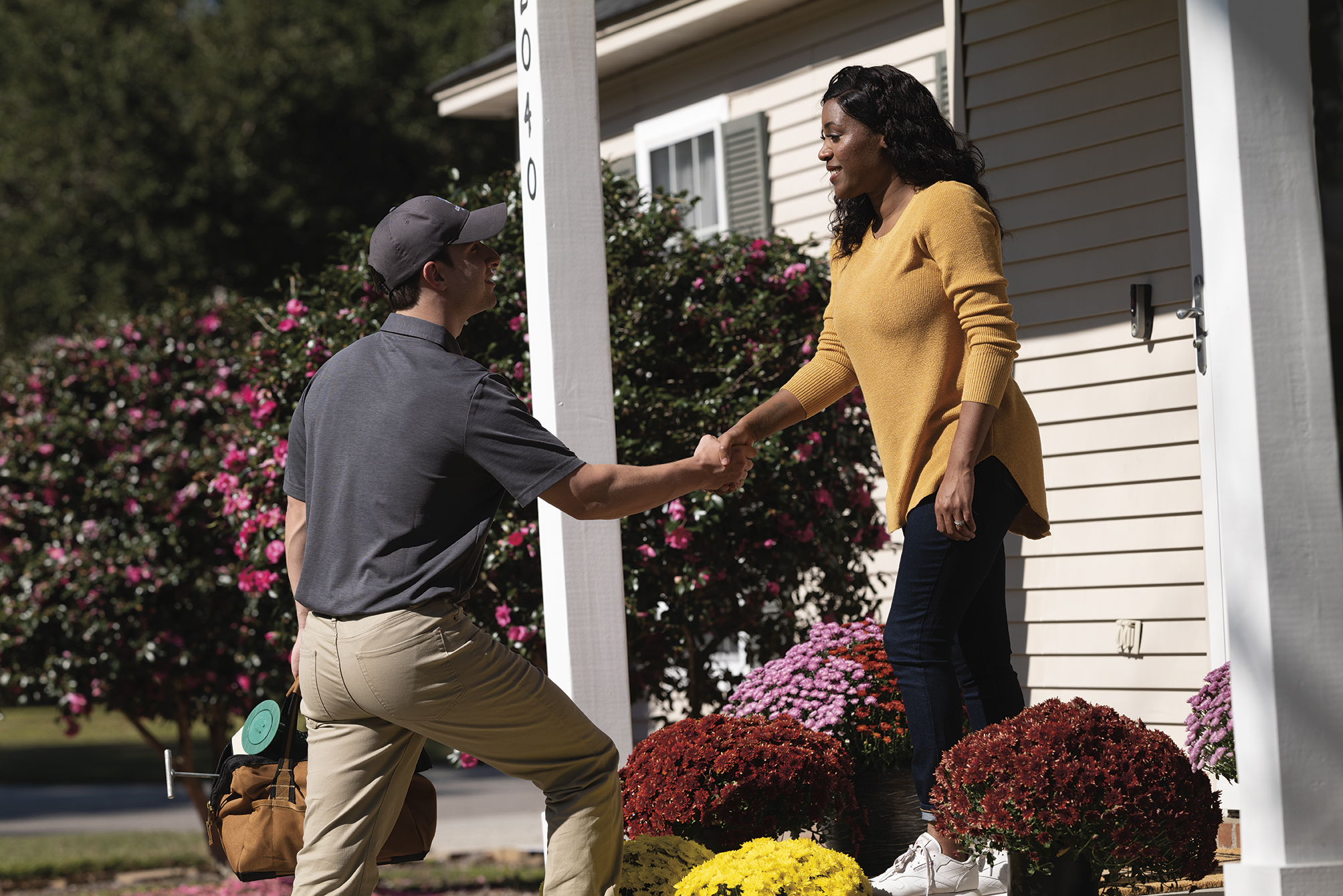 Roberts Pest Control technician meeting St. Louis homeowner for Sentricon termite consultation and free estimate