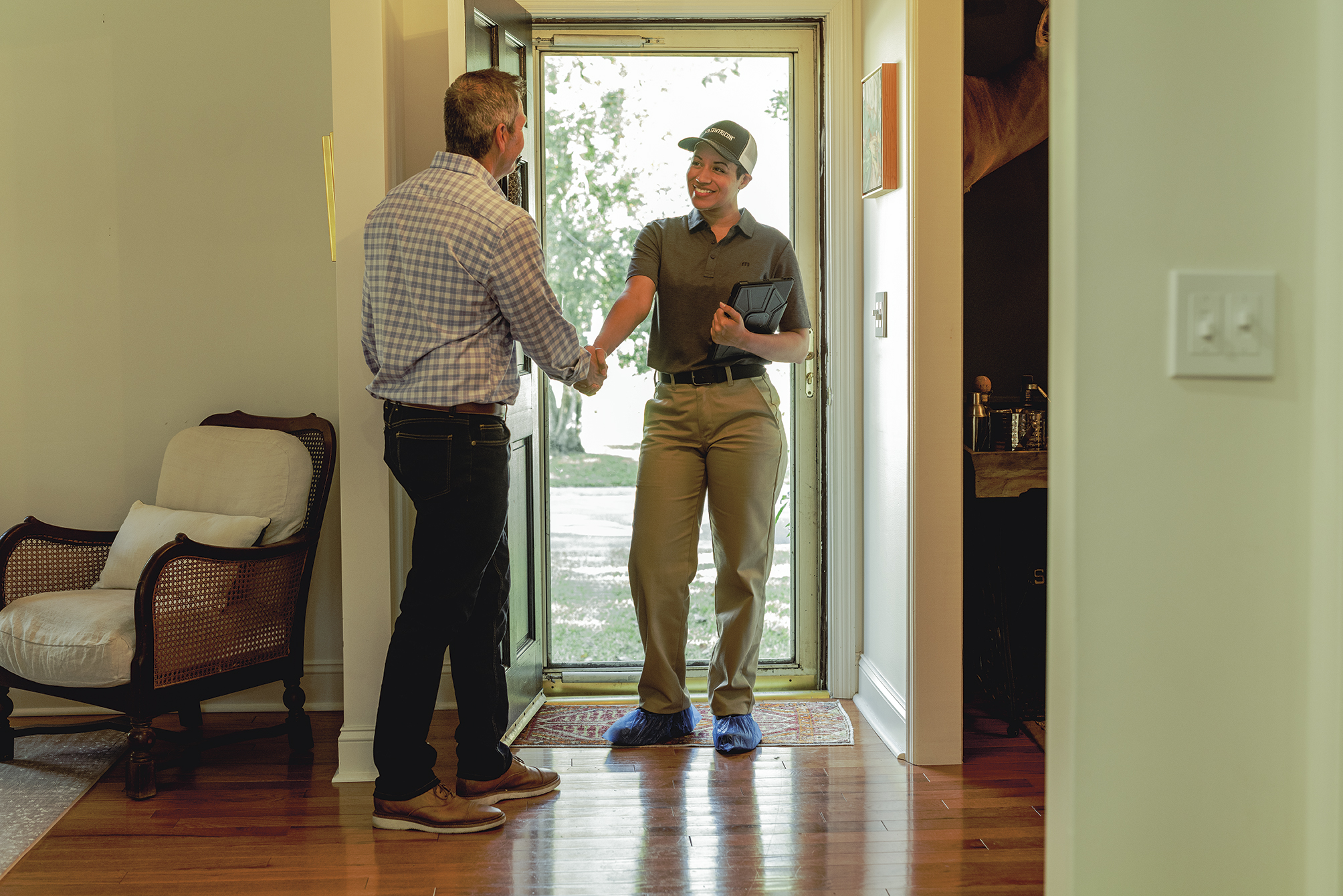 Roberts Pest Control technician greeting homeowner for termite inspection
