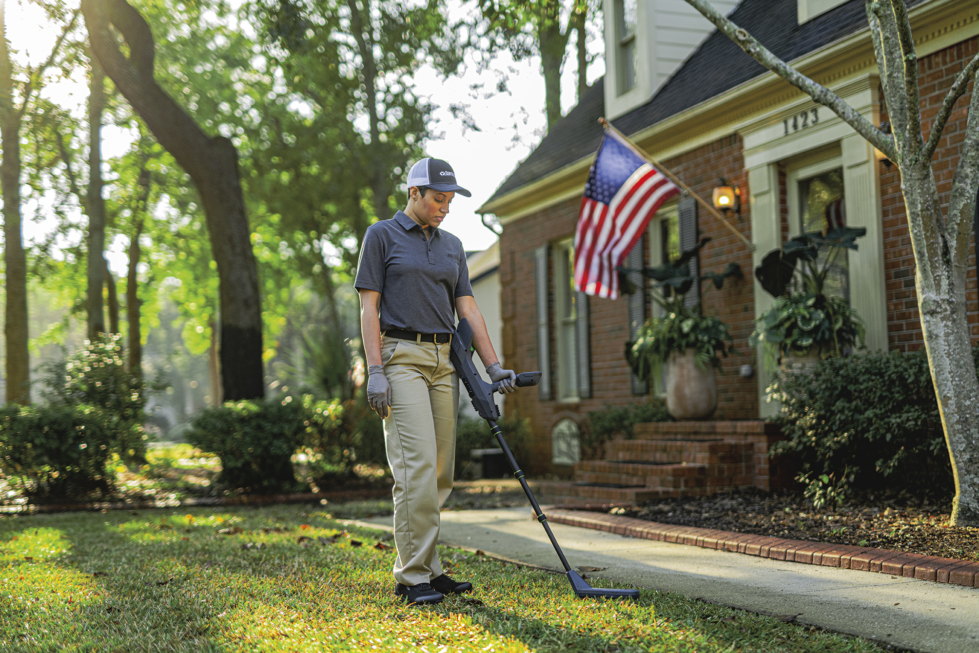 Roberts Pest Control certified technician performing thorough termite inspection around St. Louis area home