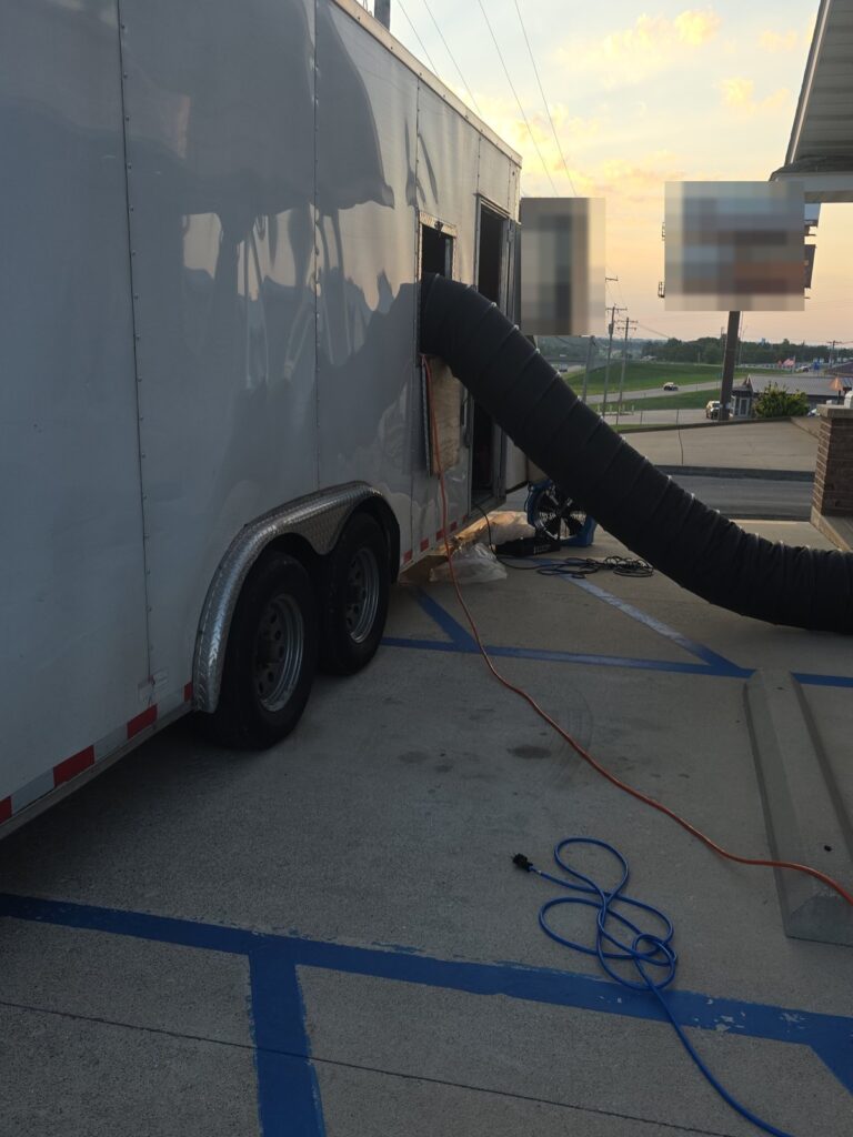 Roberts Pest Control mobile bed bug heat treatment trailer parked on-site with insulated heat ducting running into a commercial building
